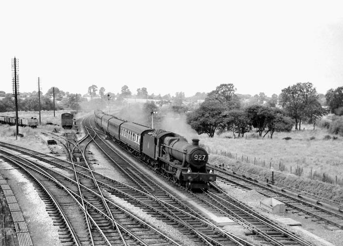 An unidentified ex-GWR 4-6-0 'Modified Hall' locomotive crosses the junction at the head of an up express service
