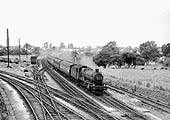 An unidentified ex-GWR 4-6-0 'Modified Hall' locomotive crosses the junction at the head of an up express service