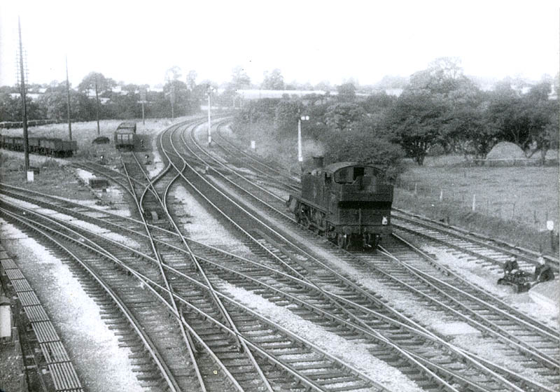 An unidentified ex-GWR Prairie is seen on the up line running bunker first back to Warwick station