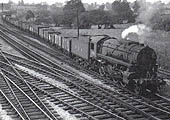 An unknown GWR 4-6-0 Star class locomotive is seen at the head of a rake of GWR crimson lake liveried coaches
