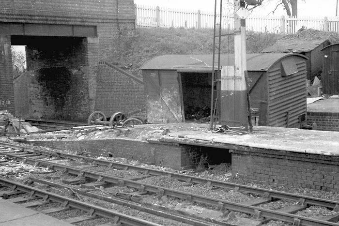 A wrecked four-wheel Vent Van, minus both axles, is seen in the bay of Hatton station on 27th April 1963