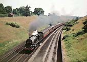 Ex-GWR 60xx Class 4-6-0 No 6018 'King Henry VI' is seen working a down express on 8th July 1962
