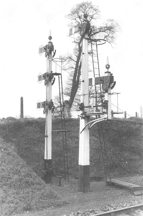 View of the gantry signal with the signal on the left controlling the loop line, which runs parallel to the bay line behind the up platform