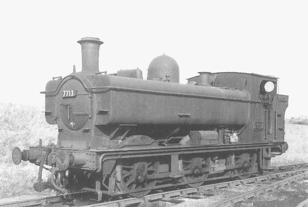 Ex-GWR 0-6-0PT 57xx class No 7713 is seen standing on one of the back sidings with the connecting line to the new station behind