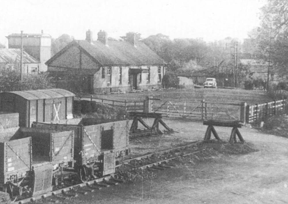 Close up showing the two buffer stops at the end at Henley-in-Arden goods yard's main sidings with the original passenger station in the background
