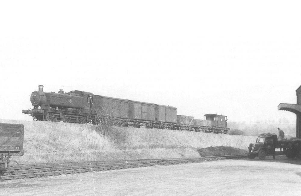 Ex-GWR 0-6-0PT 94xx class No 9432 is seen cautiously reversing down the gradient towards the head shunt in order to gain access to the yard in 1958