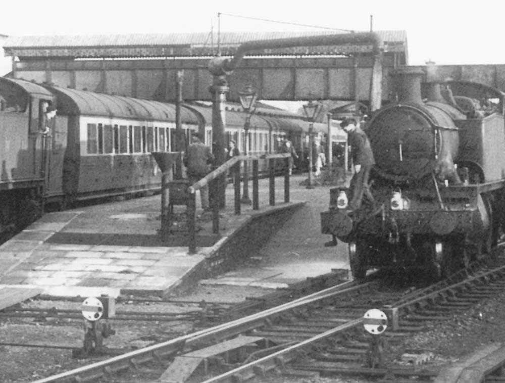 Close up of the up platform's water crane being used to fill an unidentified ex-GWR 2-6-2T Prairie locomotive with water