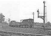 British Railways built 0-6-0PT 94xx class No 9973 is at the rear of a short goods train as it runs from the branch to the main North Warwickshire line