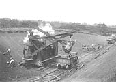 A mechanical steam shovel is being used with a gang of navvies to trim the cutting near Crockets Farm bridge