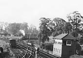 Close up showing an unidentified ex-GWR 2-6-2T Prairie tank engine at the head of a four-coach passenger train waiting for the right away