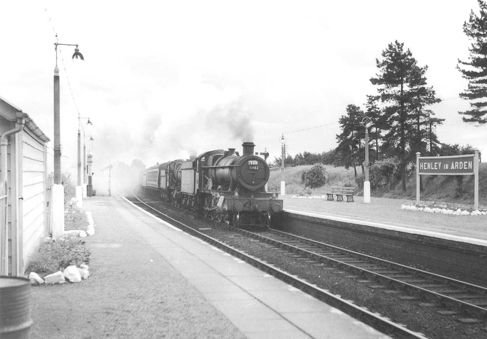 Ex-GWR 4-6-0 Hall class No 5982 'Harrington Hall' doubleheads an unidentified 2-6-0 on an up excursion from the South West of England