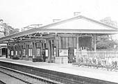 Close up showing the down platform building and the array of signs suspended beneath the canopy for the comprehensive facilities