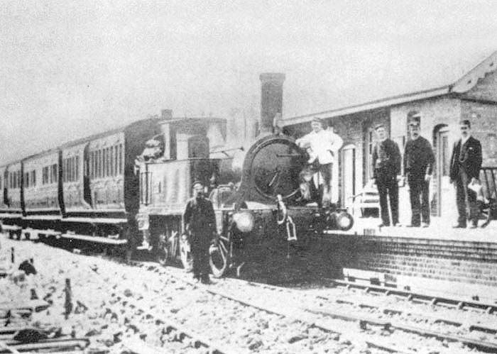 An unidentified GWR 0-4-2T 517 class locomotive stands at the head of a three-coach train comprising of four-wheel coaching stock