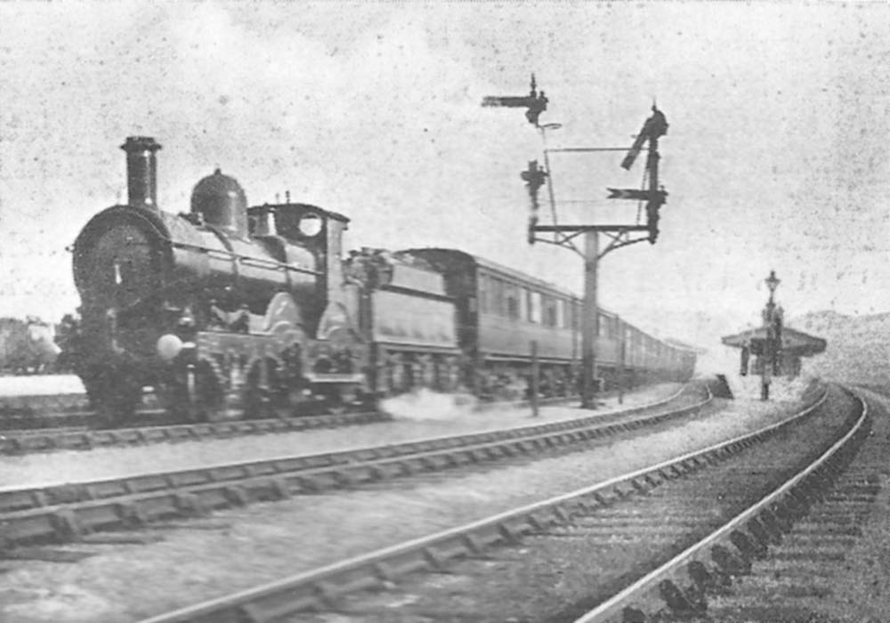 A Great Western Railway 3206 (Barnum) class 2-4-0 locomotive with an ambulance train speeds past Hockley Station