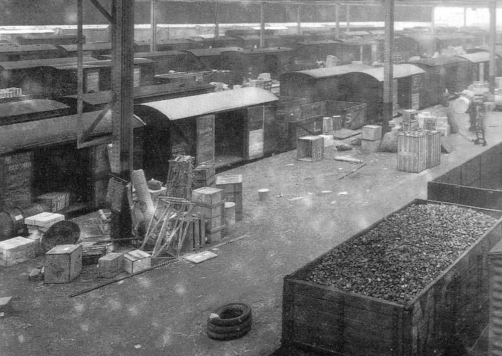 Close up showing Box Vans and open wagons at Platform No 2 within Top shed being loaded