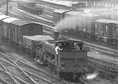 Close up showing an unidentified GWR half-cab 0-6-0PT marshalling a rake of box vans in the sidings