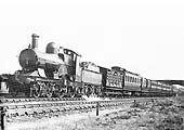 GWR 4-2-2 Achilles class 7'-8'' Single No 3050 'Royal Sovereign' is seen at the head on an express near Knowle and Dorridge circa 1909