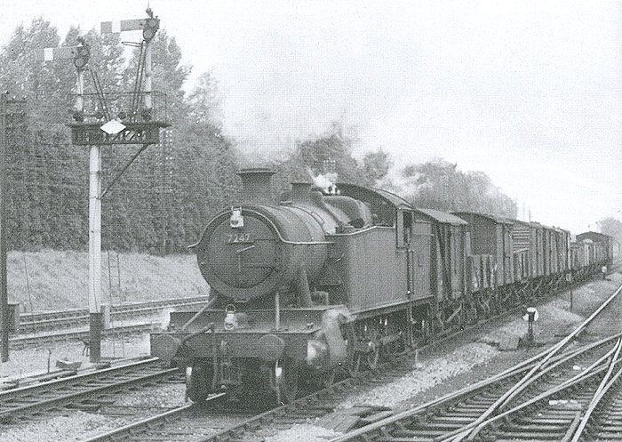 GWR 2-8-0 No 7247 is seen at the head of a Class H through freight service as it approaches Lapworth on the Up Main line