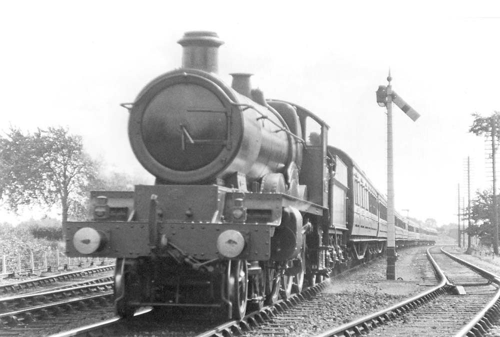 GWR 4-6-0 No 4017 'Knight of Leige' is seen at the head of a Birmingham to Paddington express train as it passes the up loop line near Knowle and Dorridge