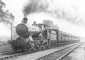 GWR 4-4-0 Straight-framed Bulldog class No 3404 'Barbados' is seen at the head of a rake of close coupled six-wheel stock near Knowle and Dorridge