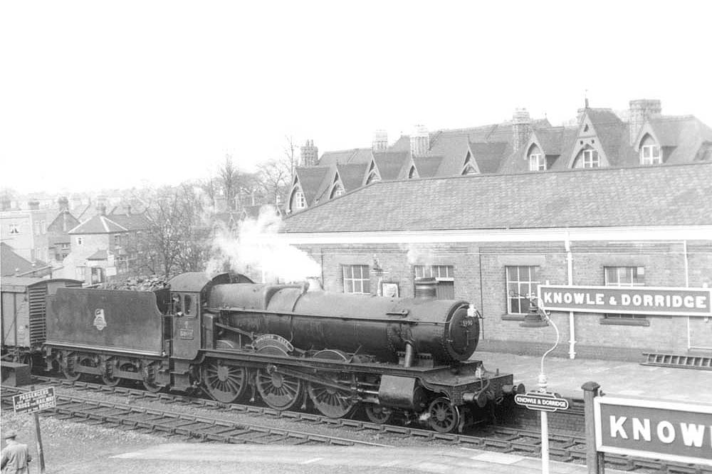 GWR 4-6-0 Hall class No 5990 'Dorford Hall' is seen entering the station at the head of a fast goods service on 22nd April 1958