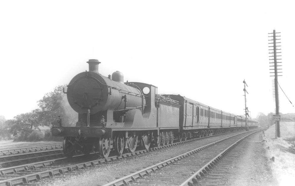 London South Western Railway's superheated Class L12 No 418 is seen at the head of an express comprised of Southern coaching stock