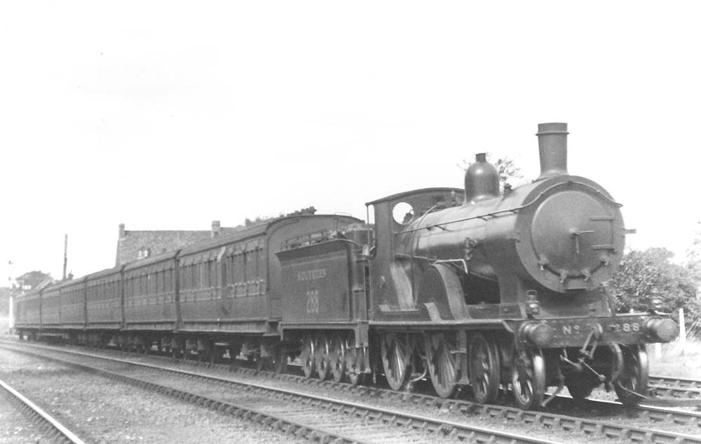 Ex-London South Western Railway 4-4-0 class T9 No 288 is seen at the head of an up express made up of Southern rolling stock in September 1926