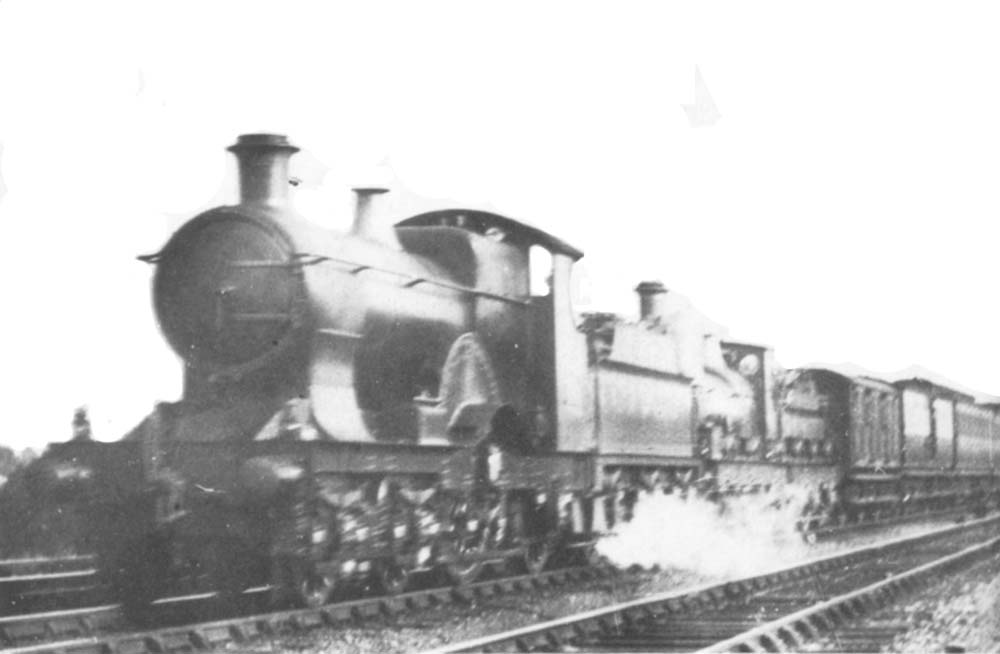 An unknown Achilles class 4-2-2 locomotive doubleheads an outside framed 0-6-0 locomotive on a down fast service circa 1910