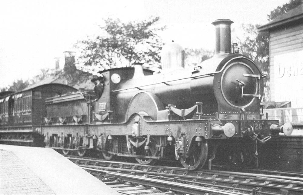 GWR Queen class  2-2-2 No 1128 Duke of York is seen standing at Knowle & Dorridge with an up local service