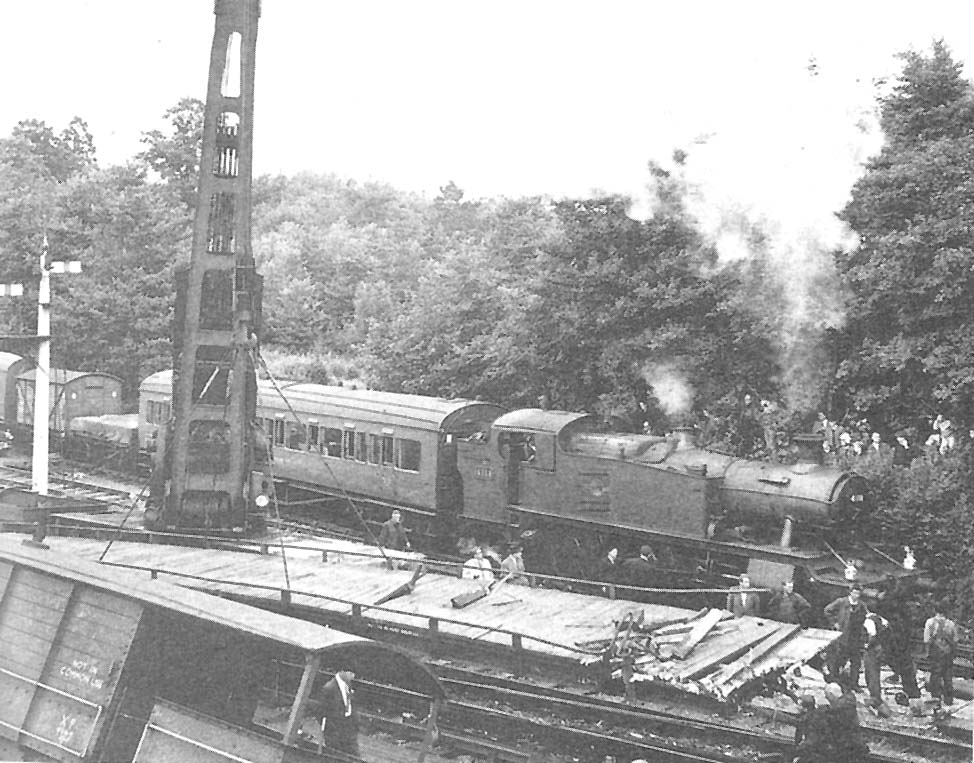 View of one of the cranes lifting debris from the site whilst other traffic continued on the adjacent lines