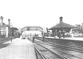 A late Victorian view of Knowle and Dorridge station showing staff standing between the platforms