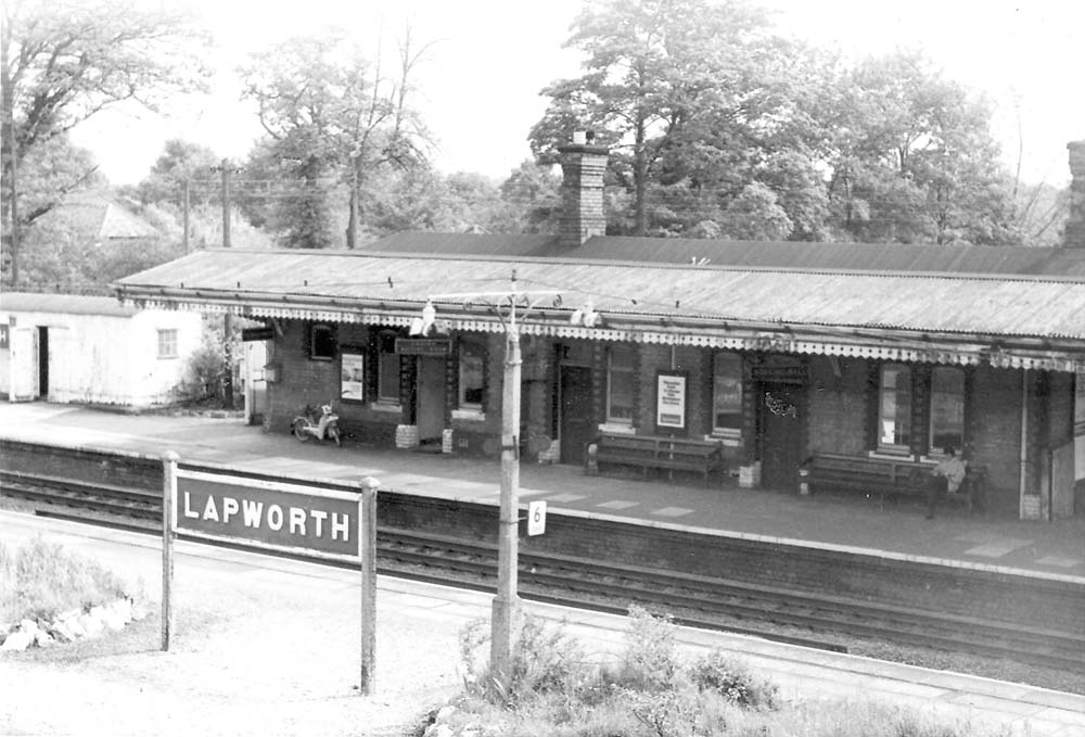 View of Platform 1 from the passenger footbridge showing the main station building and on the left the corrugated hut