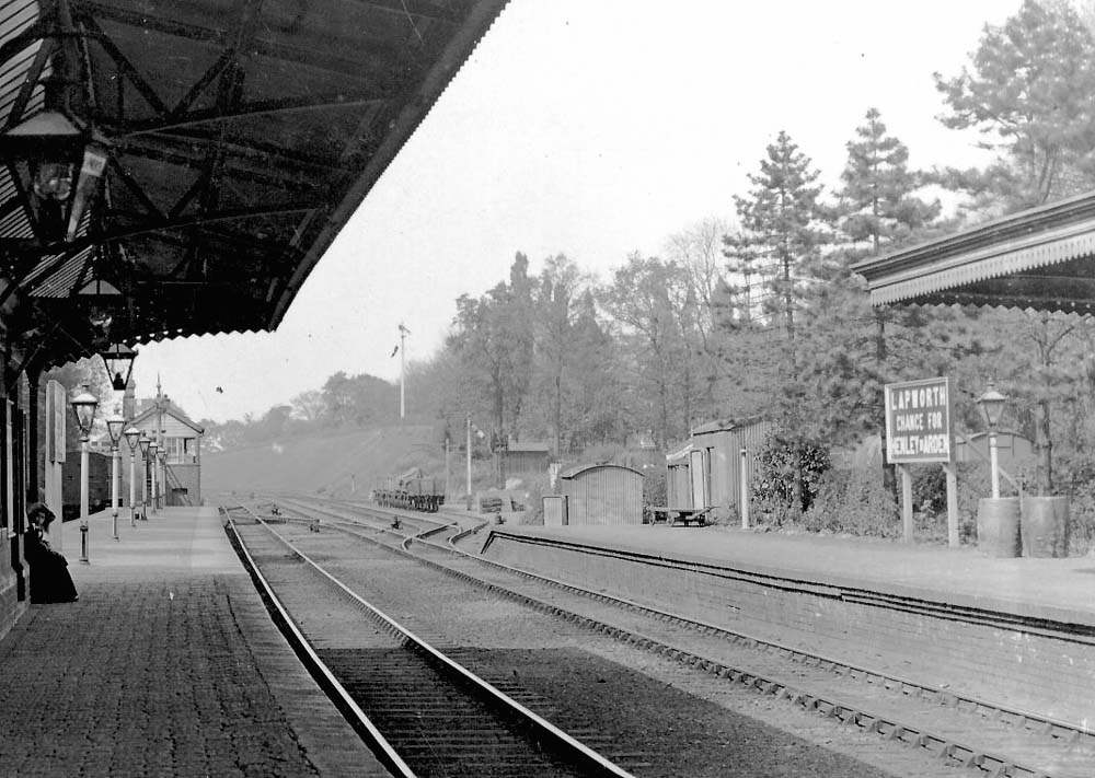 Close showing Lapworth Signal Box, the station's small goods yard opposite and the station's name board