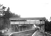 Looking towards Birmingham from the London end of the up platform as a local passenger train arrives at the station