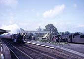 An ex-GWR 4-6-0 Hall class locomotive races through Lapworth  on the down main line with a northbound express
