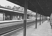 Looking along a platform one with platforms two and three on the left and the footbridge at the end of the canopies