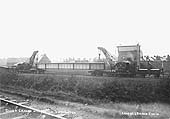 A pair of GWR steam cranes, with a girder suspended between them, are seen stabled in the carriage sidings