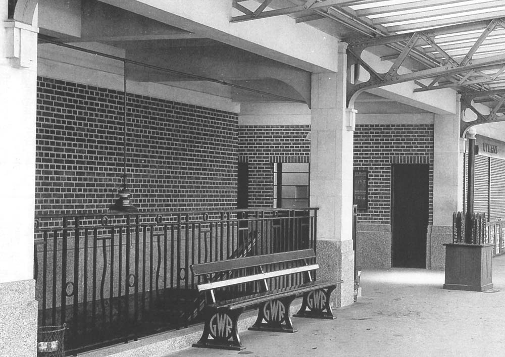 Close up showing on the left the stairs to the subway and on the right a box containing train indicator signs