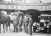 Horse drawn cab and motor taxi stand side by side outside the subway prior to the rebuilding