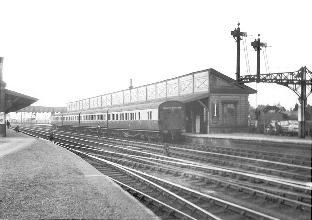 Looking towards Birmingham with with a set of commuter coaching stock standing in the down platform