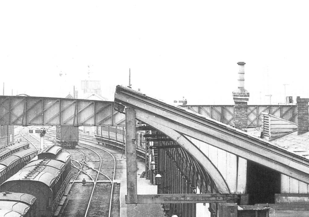 Close up view showing a variety of coaching stock stabled on the through lines and the signal box and water tank