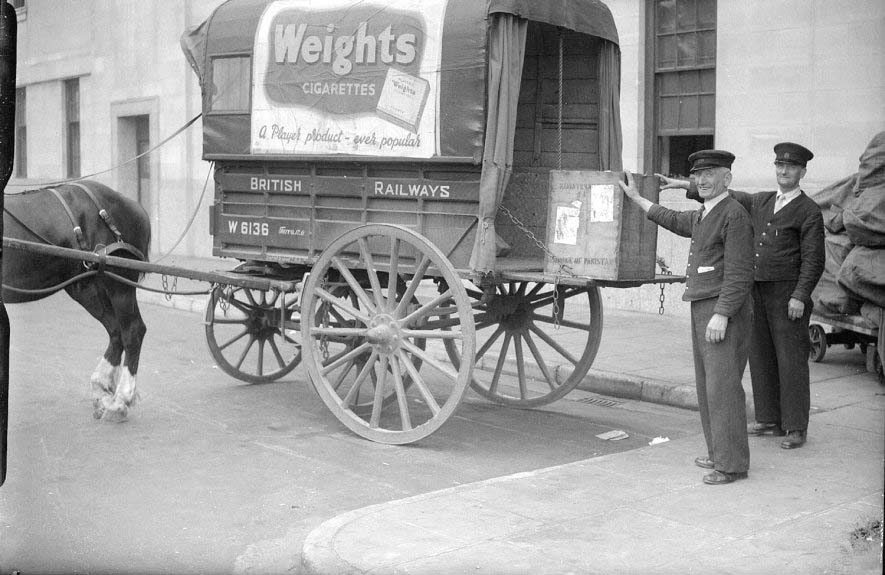 Two porters pose by the last horse-drawn cart used for goods delivery by the ex-GWR station in Leamington Spa