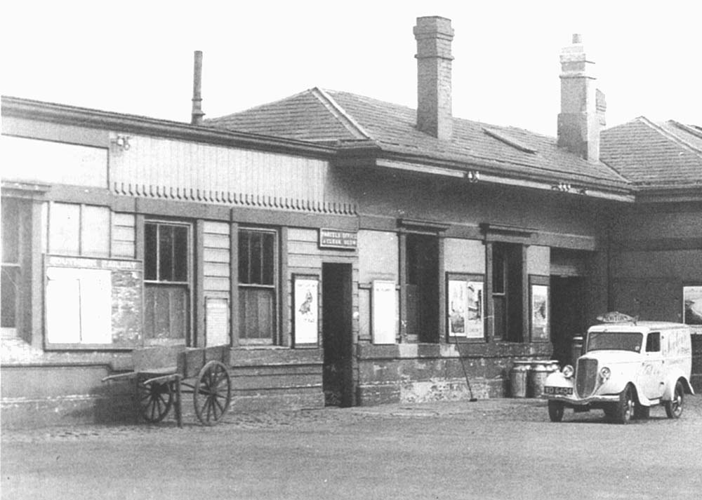 Close up showing Newton's fish van, with its fish shaped sign over the windscreen, waiting outside the parcel office