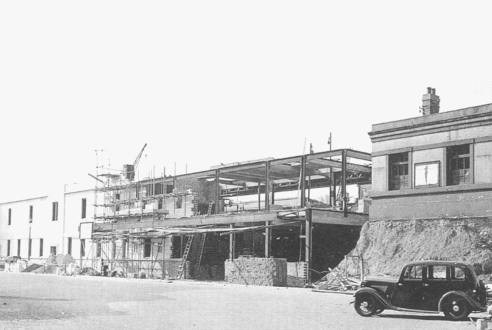 View of the steelwork for the main building and entrance to the subway to the down platform being erected