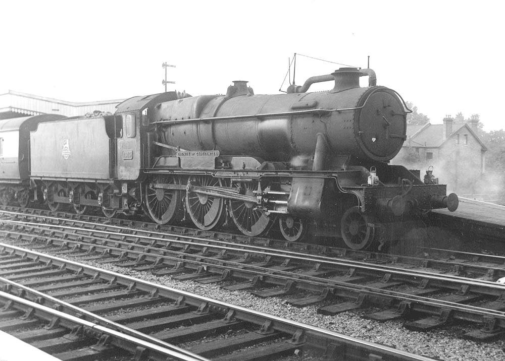 Ex-GWR 4-6-0 County class No 1015 'County of Gloucester' in a very dirty condition stands at the head of an up express train