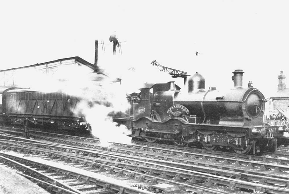 GWR 4-4-0 No 3267 Cornishman heads south on an up express with a siphon immediately behind the tender