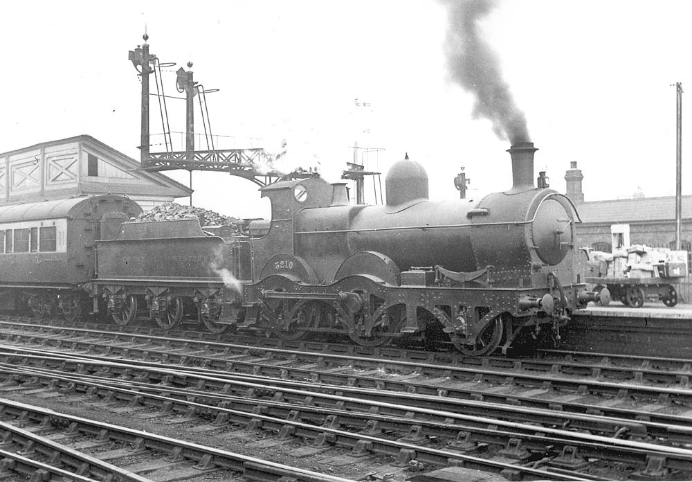 GWR 2-4-0 'Barnum' class No 3210 stands at the head of an an up local passenger train circa 1932
