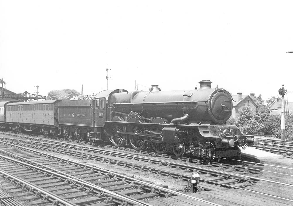 GWR 4-6-0 No 6019 'King Henry V' pauses at the head of an up express with a Siphon behind the tender
