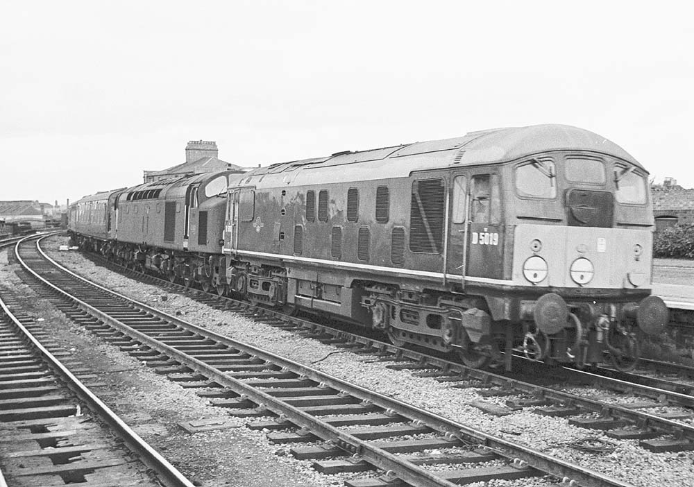 Sulzer Type 2 Diesel locomotive D5019 pilots an English Electric Type 4 locomotive on a down inter-regional Class 1 service in July 1966