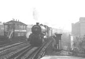 An unknown ex-GWR King Class locomotive speeds through the station on the down Inter-City express